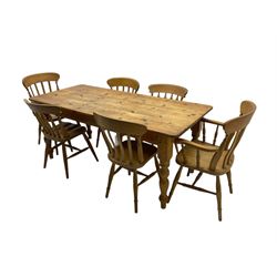 Pine farmhouse dining table, rectangular top with rounded corners, raised on turned supports; together with a set of six (4+2) spindle-back dining chairs