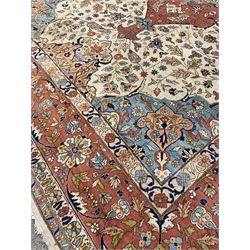 Large Persian carpet, pale ground with peach ground central medallion, the field decorated with interlacing foliate and stylised flower heads, light blue spandrels with stylised plant motifs, repeating guarded border 