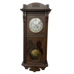 An early 20th century Art nouveau style wall clock with a French countwheel movement by Japy Freres, Paris, in an oak case with a shaped pediment, reeded mouldings and glazed panels, 7” silvered dial with a gilt slip and continental 24-hour Arabic numerals, minute track and steel spade hands, visible pendulum with a brass bob beneath, eight-day spring driven striking movement striking the hours and half-hours on a single gong rod. Movement and dial both stamped with the Japy Feres trademark.




