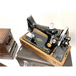 A group of five cased Singer sewing machines. 