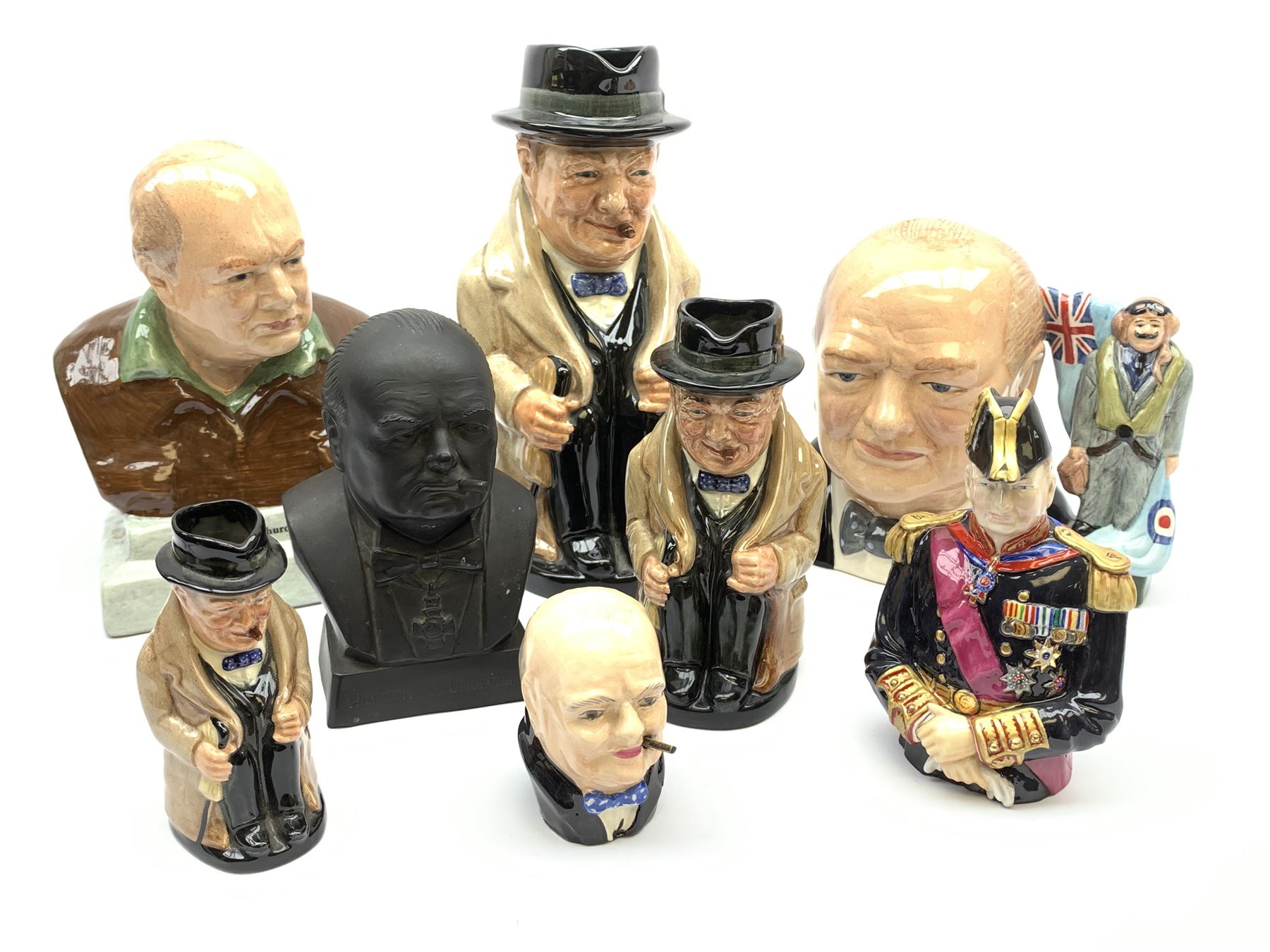 Collection of Winston Churchill figures, to include three graduated Royal Doulton toby jugs, Manor Limited Editions Forcies Churchill character jug, Bairstow Manor Pottery Bust, Bronte Sir Winston Churchill Lord Warden of the Cinque Ports snuffer, etc., together with two pieces of Crested ware. (10).