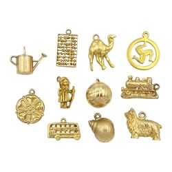Nine 9ct gold pendant/charms including wizard, dog, shell, train and bus, all hallmarked, 18ct gold camel and an 8ct gold abacus