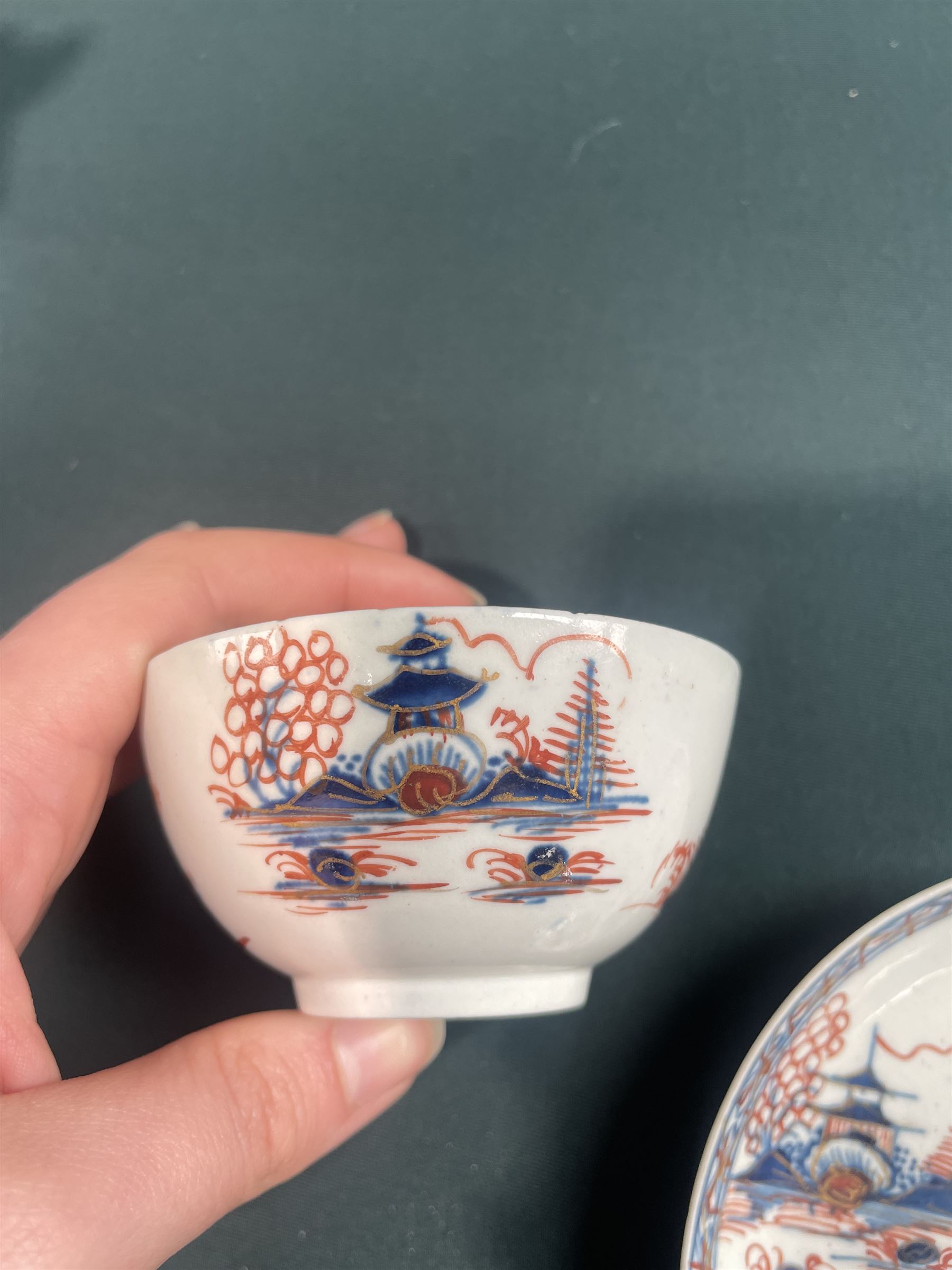 18th century Caughley tea cup and saucer of fluted design decorated in blue and gilt, blue 'S' mark, Bloor Derby coffee can and saucer in red, blue and gilt; 18th century Worcester tea bowls decorated in the Pleasure Boat or Fishermans pattern, and a Liverpool tea bowl decorated in the Penningtons Cannonball pattern