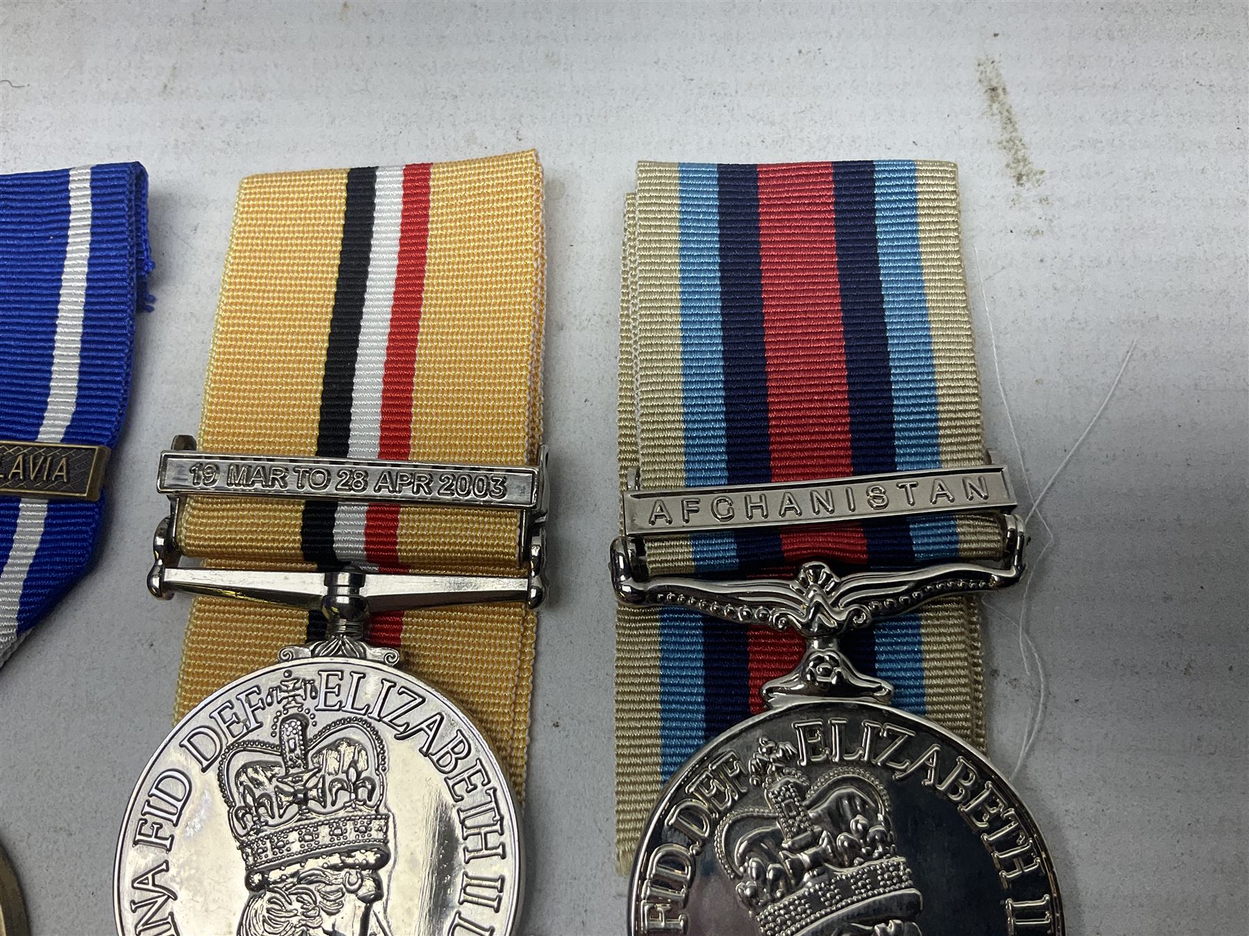 NATO Service Medal with clasp for Former Yugoslavia; together with three copy medals - Iraq Medal with clasp for 19 Mar to 28 Apr 2003 and unfitted rosette; Operational Service Medal with Afghanistan clasp; and QEII Golden Jubilee 2002 medal; all with ribbons (4)