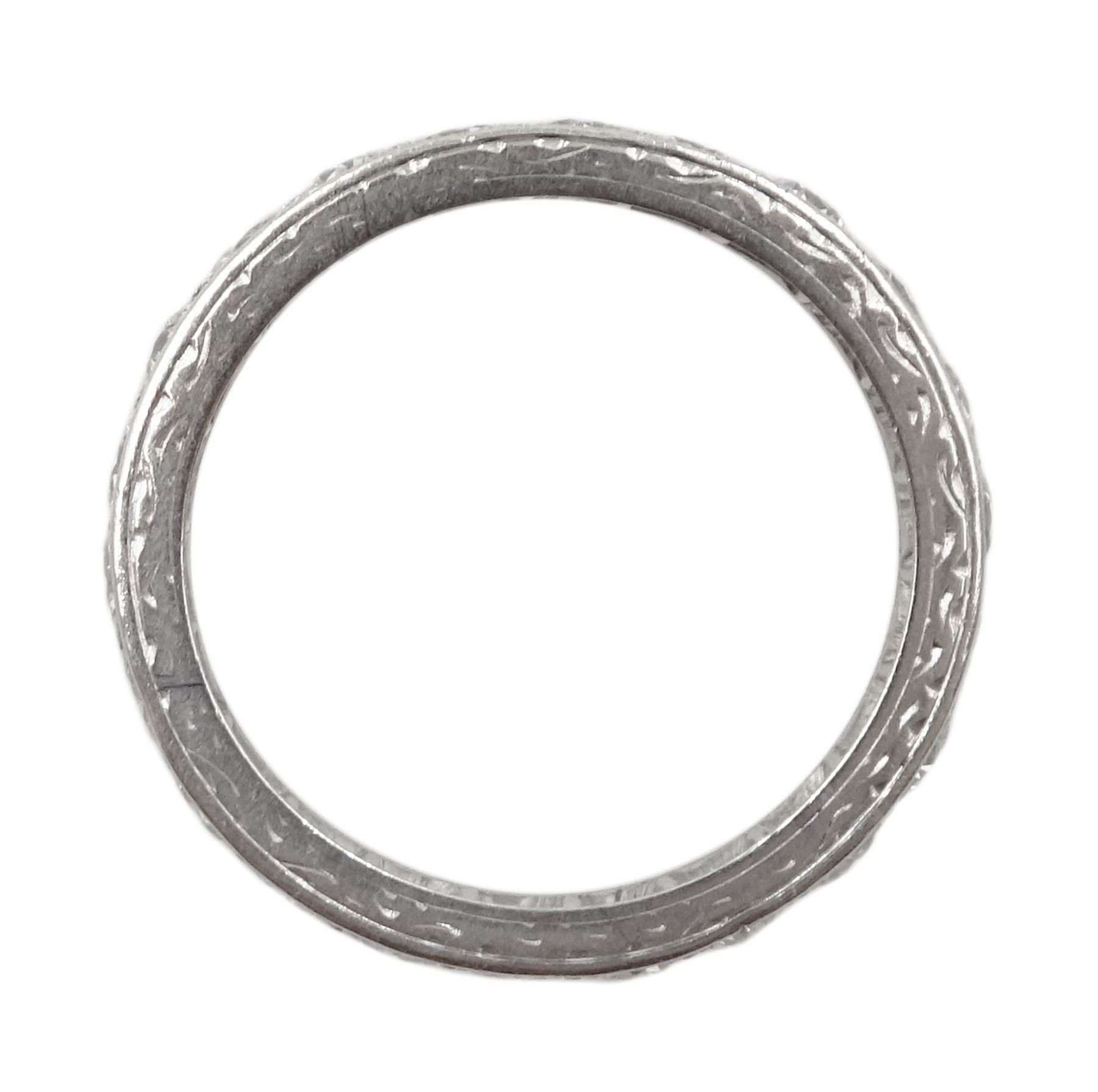 Early-mid 20th century platinum old cut diamond full eternity ring, twenty two diamonds of approx 0.06 carat, total diamond weight approx 1.30 carat, engraved decoration to the sides