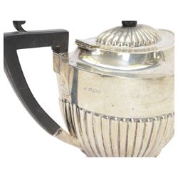 Early 20th century four piece silver tea service, comprising teapot, hot water pot, open sucrier and milk jug, all of oval part fluted form, the teapot and hot water pot with Bakelite type handles and finials, hallmarked James Deakin & Sons (John & William F Deakin), Sheffield 1918