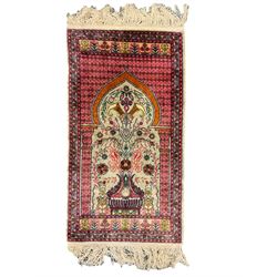 Small Persian magenta ground rug, central Mirab with flanking columns enclosing stylised urn motif with trailing foliage, the triple band border with plant motifs (86cm x 46cm); Persian red ground rug, two central floral medallions with extending flower heads, floral decorated border (106cm x 53cm) (2)
