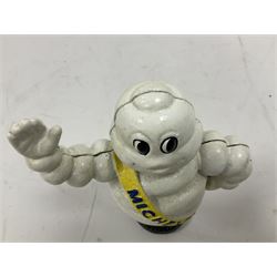 Cast iron money bank of a waving Michelin man stood on a tyre, H23cm