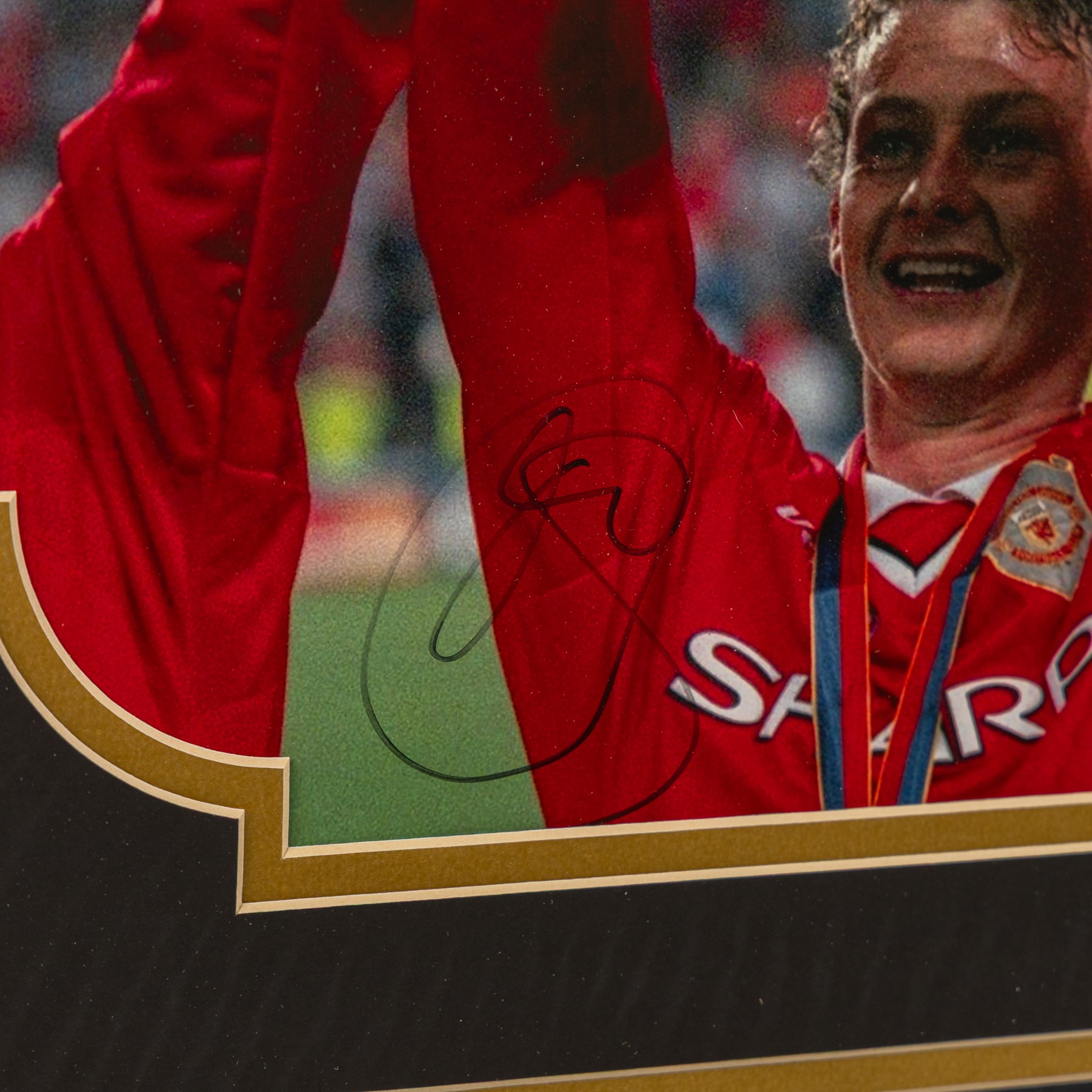 Signed Ole Gunnar Solskjaer montage, featuring a series of iconic photographs from his Manchester United career, the central photograph of him lifting the Premier League trophy signed in black marker, with certificate of authenticity from A1 Sporting Items Ltd, frame H83cm