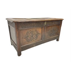 18th century oak blanket chest or coffer, rectangular hinged top with three panels and moulded edge, frieze carved with lunette and acanthus leaf decoration, two front panels carved with scrolling motif, raised on stile supports