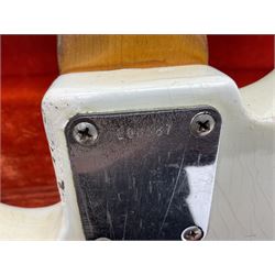 1963 Fender Jazz three-knob bass guitar; impressed with date code 7AUG63A on end of neck and serial no.L08587 on back plate; all original but re-finished in white in the 1970s; sold with photographs of the instrument in the 1960s with original finish and in the 1970s re-finished; L117.5cm; in original hard carrying case; Provenance: the professional guitar of Howard Livett from new to his death in 2005. Howard played in The Humperdincks, the backing group for Englebert Humperdinck, also played in the backing group for Max Bygraves and in the band Hedgehoppers Anonymous. The guitar is also sold with a manuscript letter of provenance from Howard's wife.
