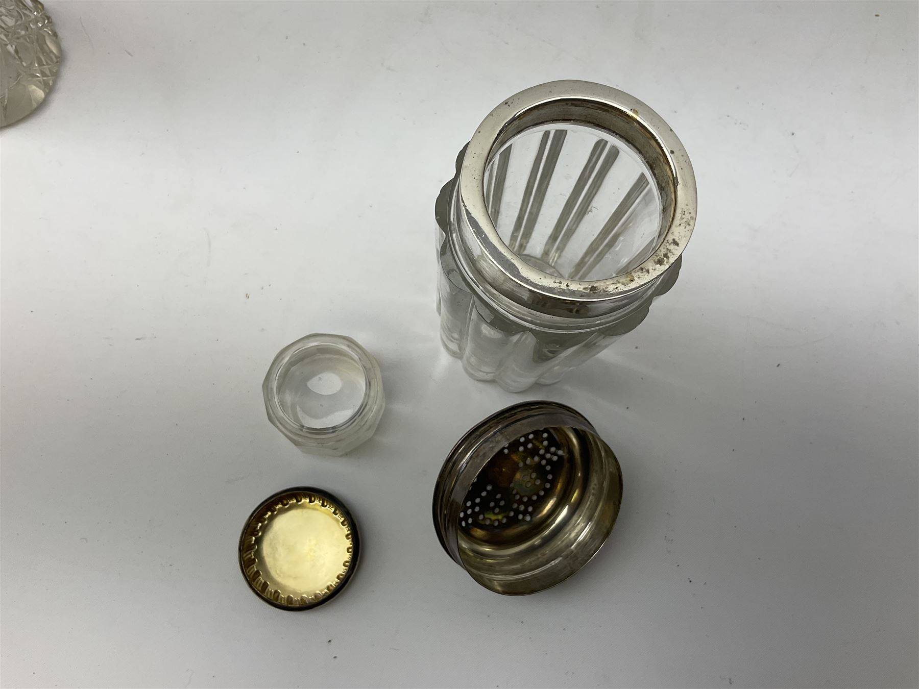 Edwardian silver mounted purse, with circular panel engraved with initials, and hammered finish, hallmarked William Comyns & Sons, London 1903, H14cm, together with three dressing table glass jars with hallmarked silver covers, and a hallmarked silver mounted buffer 