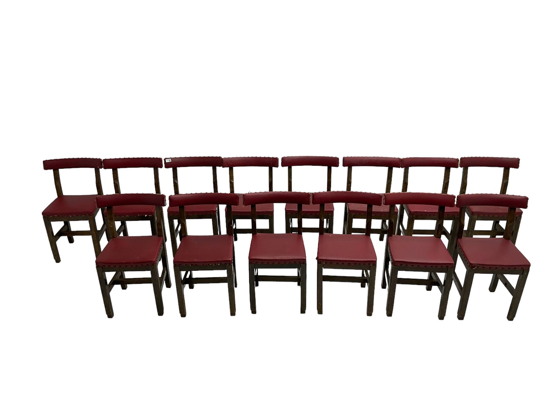 Set fifteen early 20th century oak school chairs, back rail and seat upholstered in claret red faux leather with studwork, raised on square supports united by H-stretcher (15)