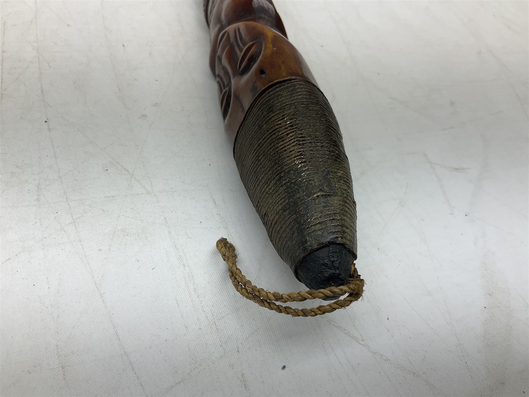 Tribal Art - an African axe, possibly Yoruba, the bone shaft carved as two cord bound stylised figures with iron fan-shaped blade, L35cm overall; and 19th century harpoon or spear head of square section with two long fixing arms on cut-down ash shaft L57cm (2)