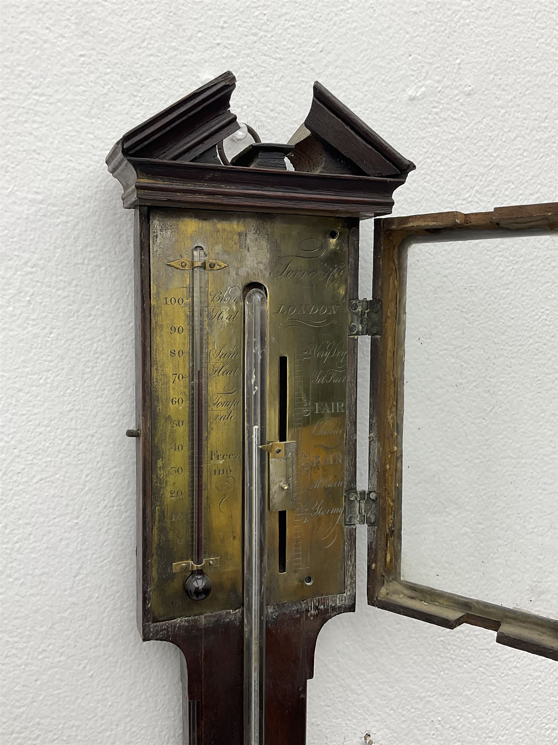 William IV mahogany stick barometer signed “Torre & Co, London”, with an architectural broken pediment above a glazed door, exposed mercury tube with glass bulb cistern behind a turned mahogany cover, engraved register plate with a scale from 27” to 31” with a manual vernier and spirit filled thermometer from zero to a hundred degrees fahrenheit, engraved with the makers name and weather predictions. 
Torre & Co are recorded as Barometer manufacturers, Leigh Street, Red Lion Square, London c1830.
