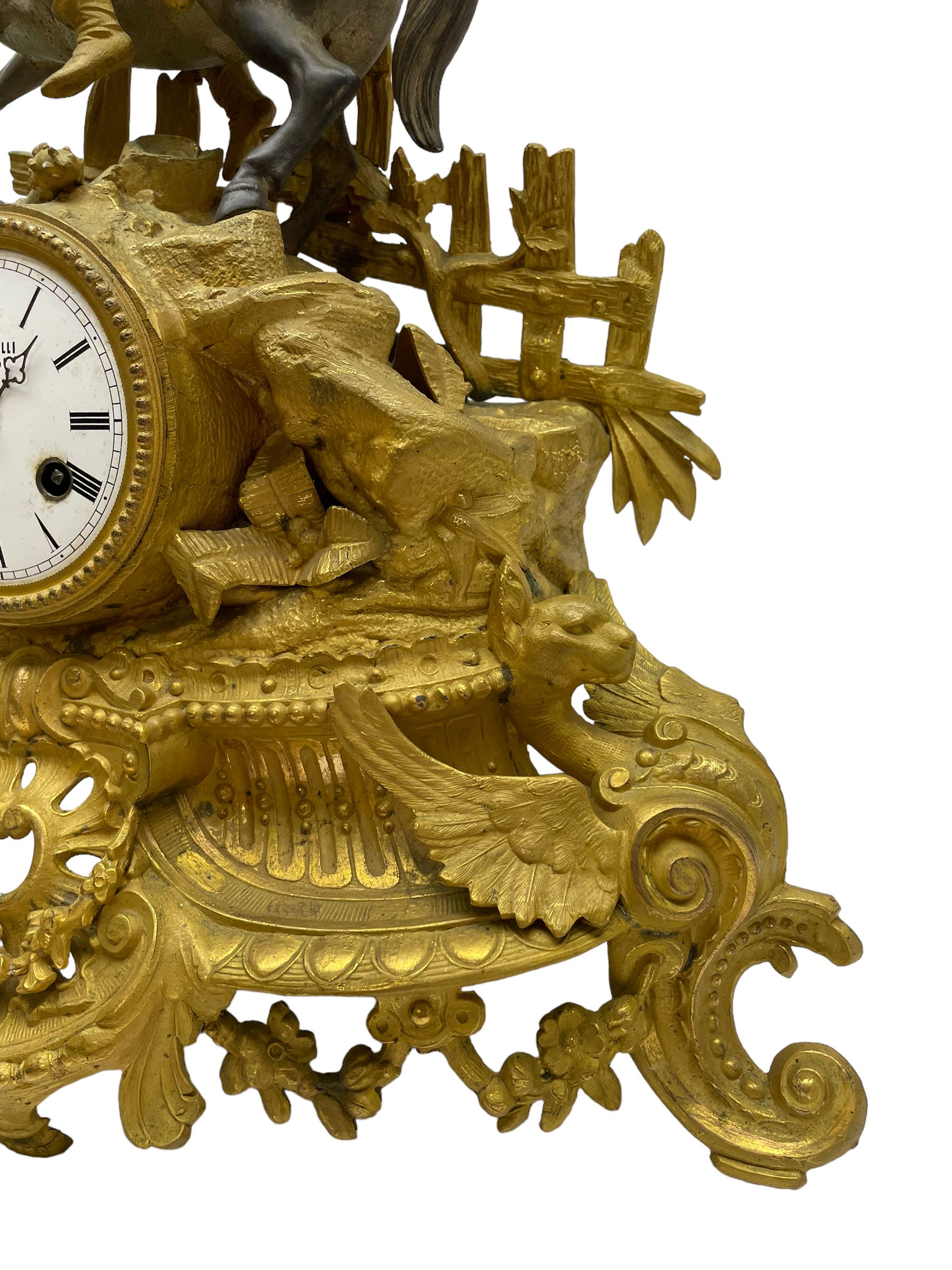 French - late 19th century 8-day gilt spelter mantle clock retailed by J Vassalli of Scarborough c1890, sculptured with an oriental 16th century representation a Mughal warrior slaying a leopard, raised on a profusely  decorated base with scroll work and splayed feet, white enamel dial with Roman numerals, minute track and steel hands, Parisian twin train countwheel striking movement, striking the hours and half-hours on a bell. With pendulum & Key.  