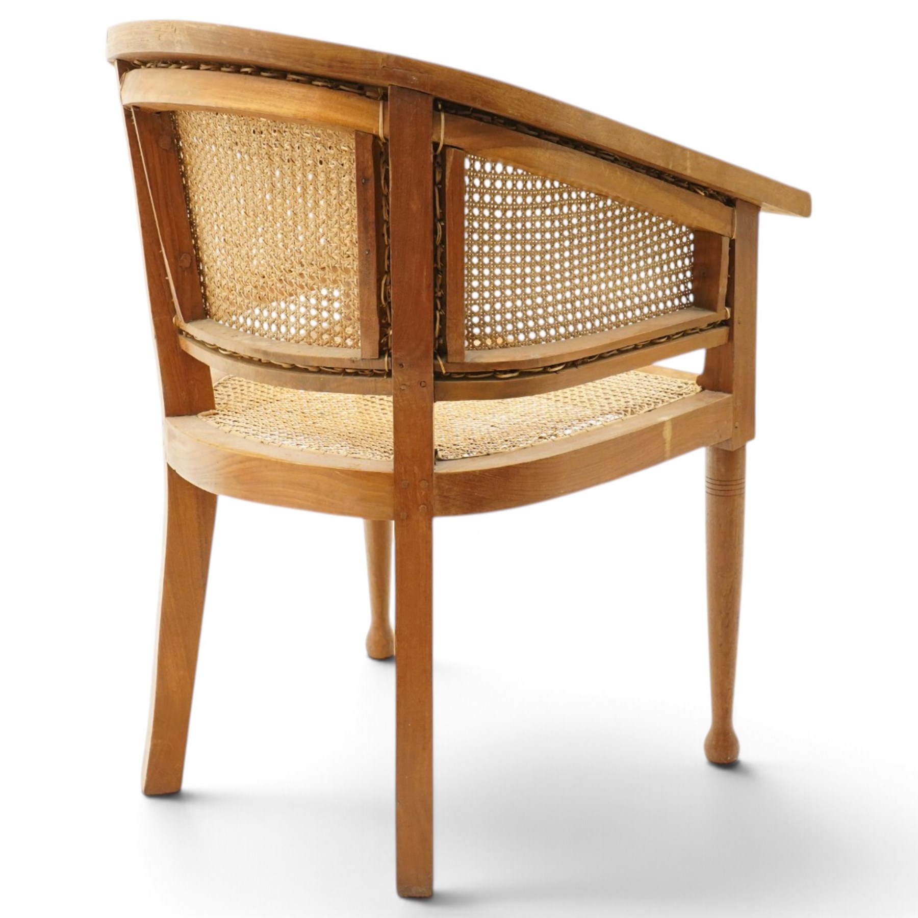 Late 20th century Anglo-Indian teak framed bergère armchair with canework back and seat, raised on tapering supports
Provenance: purchased Liberty & Co in the 1990s from the oriental line