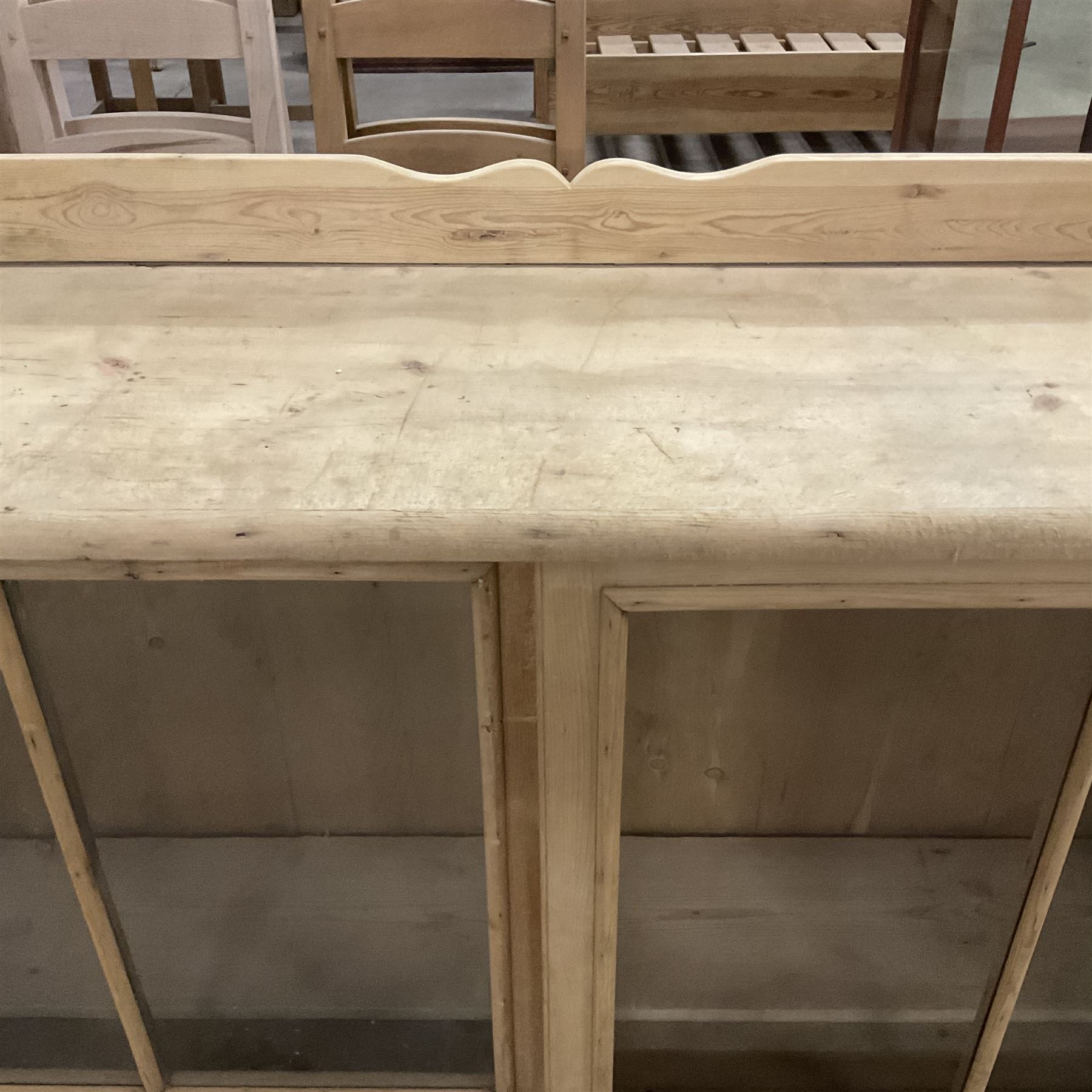 19th century pine cabinet, raised shaped back over rectangular top, enclosed by two sliding glazed doors, on turned feet - THIS LOT IS TO BE COLLECTED BY APPOINTMENT FROM THE OLD BUFFER DEPOT, MELBOURNE PLACE, SOWERBY, THIRSK, YO7 1QY