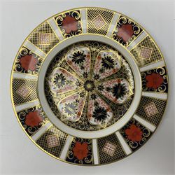 Two Royal Crown Derby Imari plates, decorated in the 1128 pattern, together with Royal Crown Derby seated Cat, without stopper and another Imari plate, largest plate D22cm