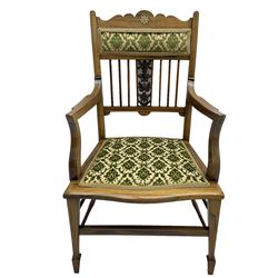 Edwardian inlaid rosewood salon suite, comprising of two seater settee, armchair, and three chairs, shaped cresting rail with ivorine stringing over stick back with pierced foliate carved splats, upholstered in foliate patterned green and ivory fabric, raised on square tapering supports with spade feet