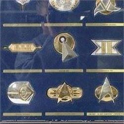 Franklin Mint The Official Star Trek Insignia Collection, set of twelve sterling silver insignia with gold plated decoration, all stamped 925 sterling with certificates of authenticity, contained within a wooden glazed display case, case H56cm