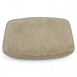 Late 20th century wingback armchair and matching footstool, upholstered in beige embossed fabric with brass stud edging, on cabriole legs and splayed rear legs, together with a matching footstool on turned supports terminating in brass castors (Stool H 42cm, W 75cm, D 47cm)