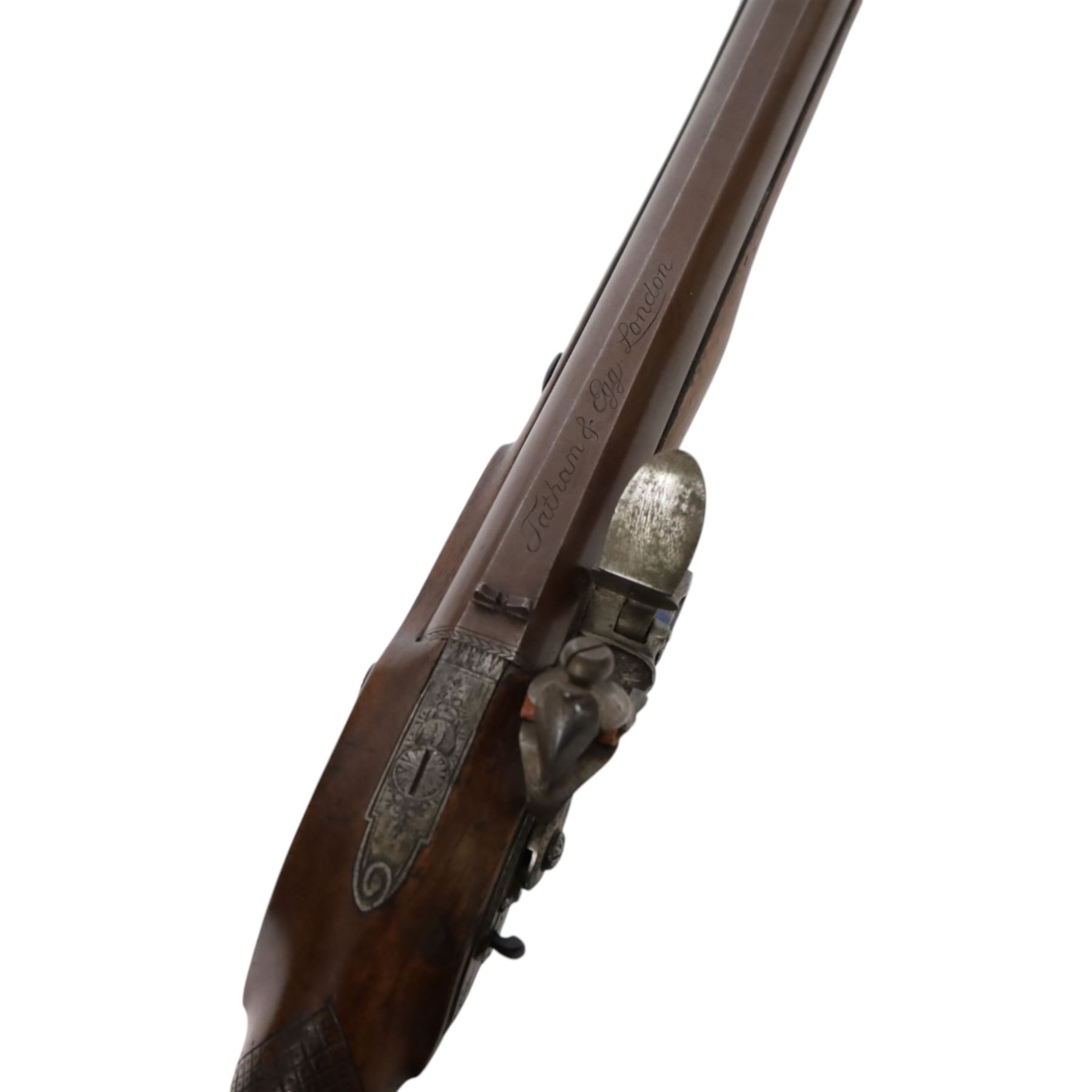 19th century British flintlock pistol by Tatham and Egg, with 21cms Damascus steel sighted barrel with original browning, marked along the top Tatham and Egg London, ramrod beneath, tang and trigger guard engraved with floral scrolls, figured walnut stock with chequered grip and steal butt plate, together with Dixon & Sons Sheffield, three way pistol powder flask, pistol overall L34cm
