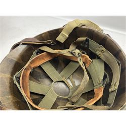 American first type paratrooper helmet with post-WW2 strap and D-rings and later 1944 liner bearing Firestone Tyre and Rubber Company mark; green textured finish