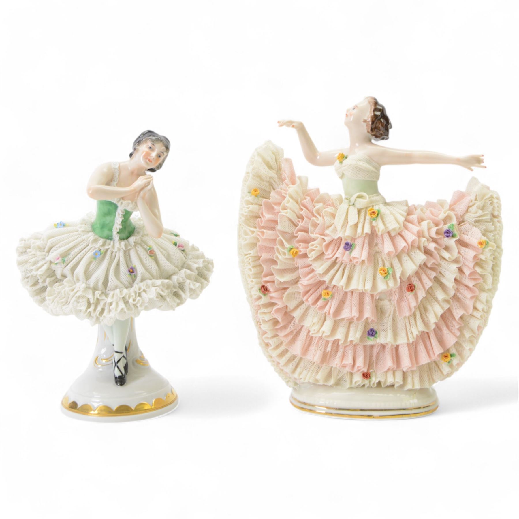 Two Continental lace figures, each modelled as a female dancer with lace skirts and lace trimmed bodice, upon a gilt detailed base, each marked beneath, tallest example H23cm