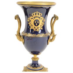 19th century Sevres style ormolu mounted porcelain twin handled urn, the body decorated with a gilt crowned crest of three fleur de lis against a cobalt ground, with spurious Sevres mark beneath, H26cm
