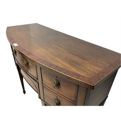George III mahogany bow-fronted sideboard, mahogany banded top over three drawers and cupboard, fitted with lion mask and hoop handles, on square tapering supports with spade feet