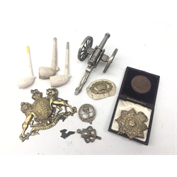  Five Military metal badges, cased Victorian Industrial Exhibition bronze medallion, model cannon and three clay pipes   