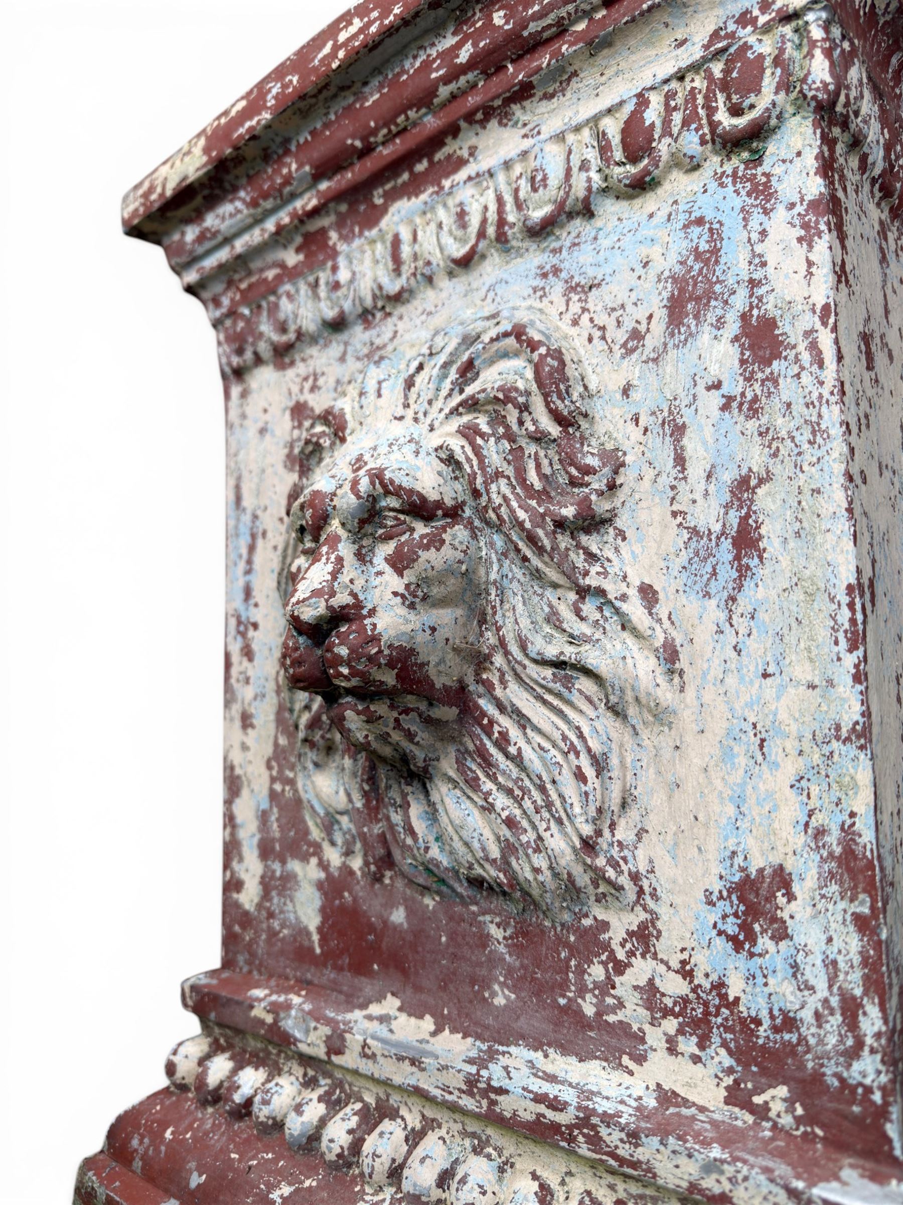 Early 20th century terracotta pedestal, square form with egg and dart detail, four lions masks to either side, finished in distressed cream paint