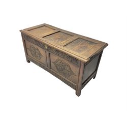 18th century oak blanket chest or coffer, rectangular hinged top with three panels and moulded edge, frieze carved with lunette and acanthus leaf decoration, two front panels carved with scrolling motif, raised on stile supports
