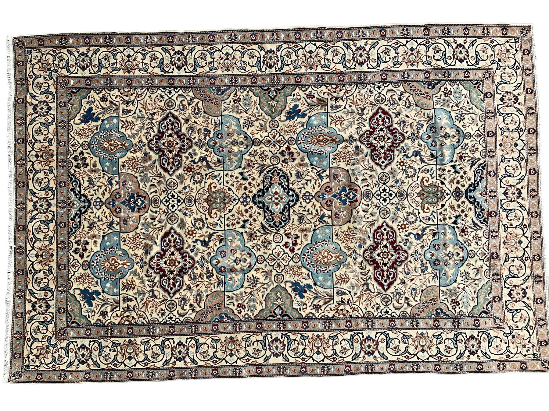 Persian Nain ivory ground rug, wool with silk inlay, the field decorated with stylised gul motifs with palmettes surrounded by interlacing foliate patterns, the guarder border decorated with repeating flower heads and scrolling vines