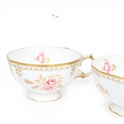 Modern Royal Crown Derby tea set for six place settings, decorated in the Royal Pinxton Roses pattern, comprising tea cups, saucers, small dishes, side plates, dessert plates, one serving plate, twin handled lidded sucrier and milk jug