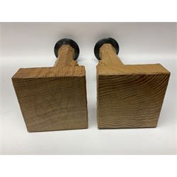 Mouseman - pair of tooled oak candlesticks, wrought iron sconce with drip tray over tapered octagonal column carved with mouse signature, terminating to stylised leaf carved square base, by the workshop of Robert Thompson, Kilburn
