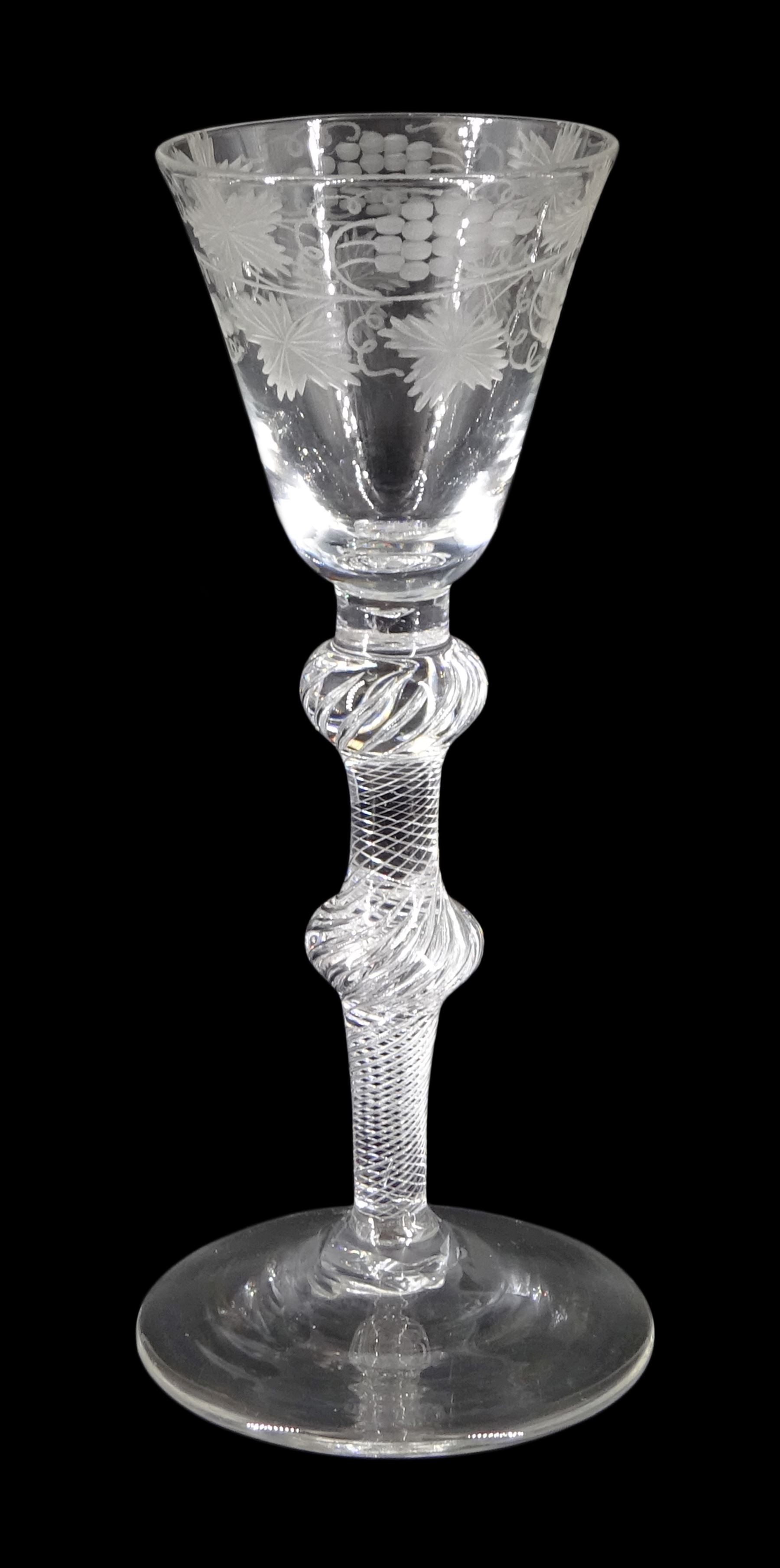 Mid 18th century wine glass, the funnel bowl engraved with fruiting vines upon a single series air twist double knopped stem and conical foot, H16.5cm