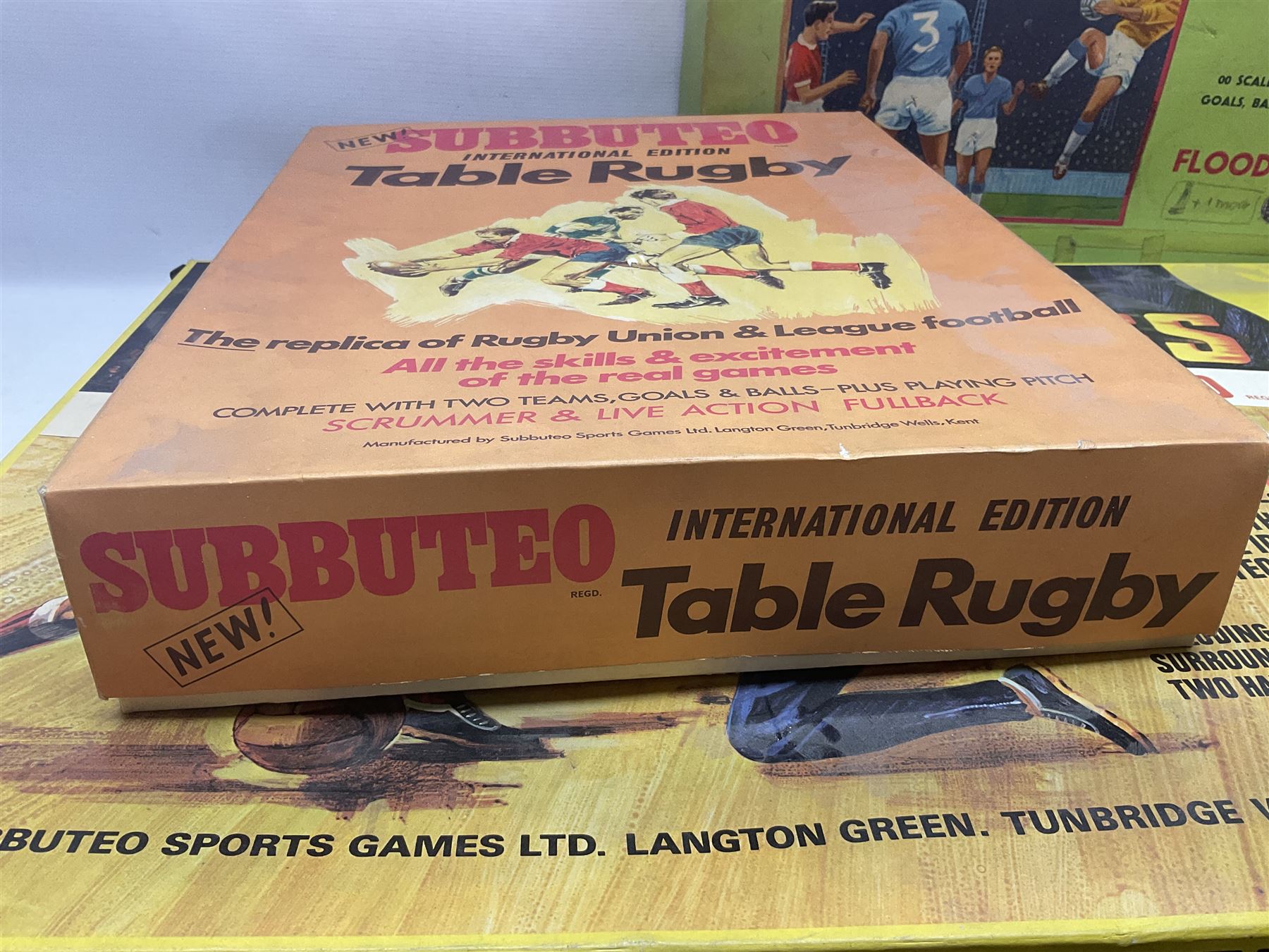 Subbuteo - three boxed sets comprising Football Express with two five-a-side teams and floodlighting; Continental with four teams and accessories; and International Edition Table Rugby with two teams; together with a Real Madrid 1974-75 League Champions pennant (4)