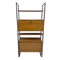 Staples Ladderax - mid-20th century teak and metal framed modular wall unit, fitted with central fall-front cupboard enclosing correspondence dividers, over secondary separate teak fall-front cupboard, adjustable shelf to top