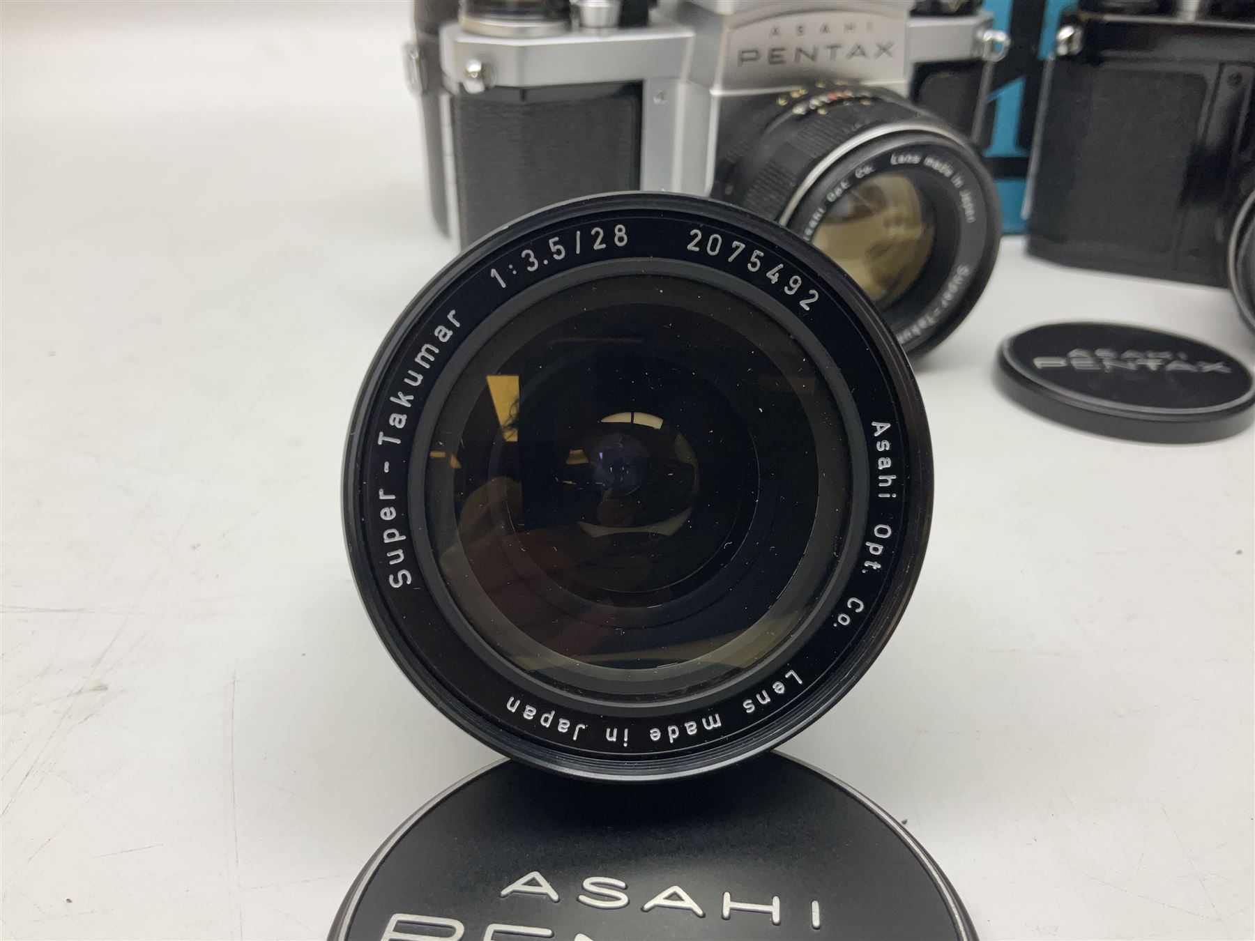 Asahi Pentax S1a camera body, serial no. 707071, with 'Super-Takumar 1:1.8/55' lens, serial no 2124044, together with Asahi Pentax Sv camera body, no. 1925617 with 'Super-Takumar 1:2/55' lens, serial no. 2770153, Asahi Pentax Meter, 'Super-Takumar 1:3.5/28' lens, serial no. 2075492 and 'Super-Takumar 1:4/150' lens, serial no. 1461613  