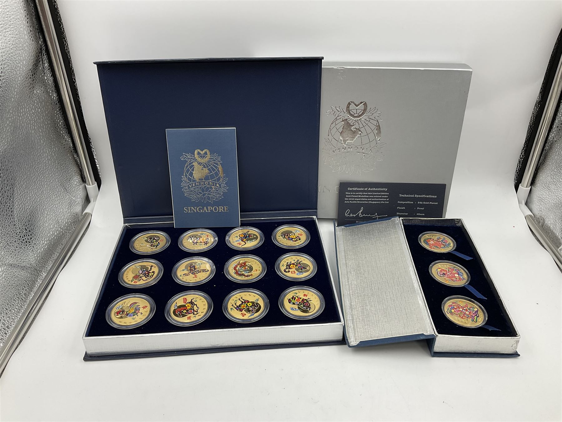 Singapore Venhonia commemorative medallion collection and a Tiger Beer commemorative three-medallion collection, both cased with certificates