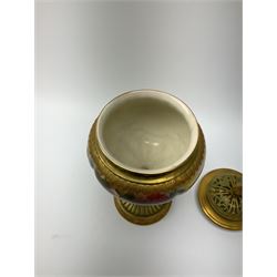 A Royal Worcester potpourri vase and cover, shape 1813, the bulbous body hand painted with pink roses and signed A Watkins, supporting a gilded and burnished pierced cover, upon a moulded stem with zoomorphic mask detail and circular foot, with puce printed mark beneath, H24cm