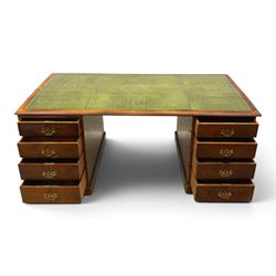 Edwardian mahogany office desk, recatangular top with green inset leather writing surface, fitted with two banks of four drawers, brass swan neck handles with ornate backplates