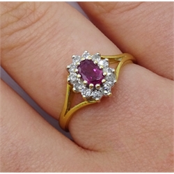  18ct gold oval ruby and round brilliant cut diamond cluster ring, hallmarked  