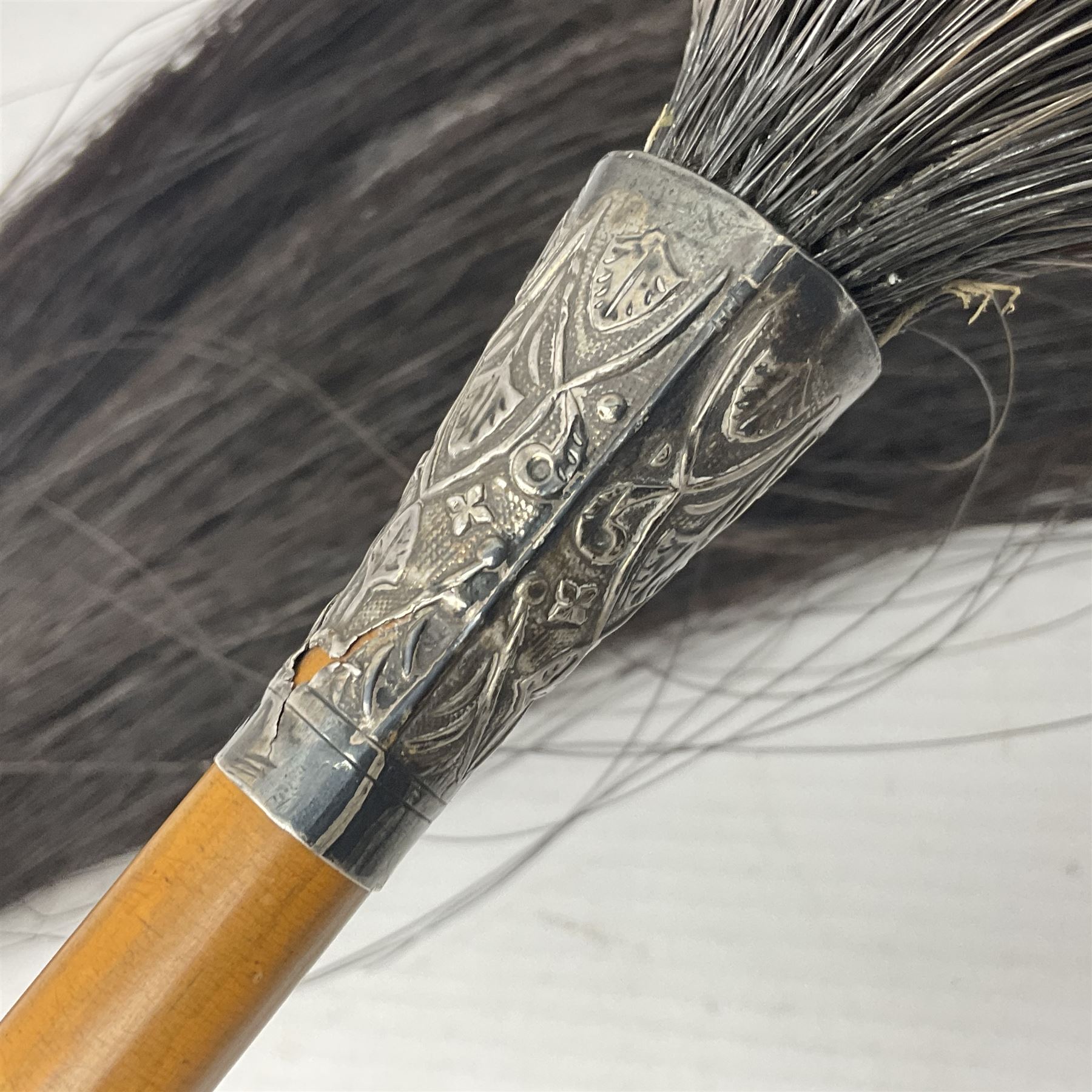 Brown Bess type socket bayonet the 40.5cm fullered triangular blade stamped WK, L52.5cm overall; malacca cane swagger type stick with white metal mounts and horse hair fly whisk; and another plain ebonised swagger stick (3)