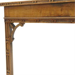 George III Chippendale design mahogany table, the rectangular hinged top with geometric carved edge, opening to reveal a baize-lined interior supported by twin concertina rear gateleg supports, over a banded frieze and pierced C-scroll spandrels, the inner chamfered square supports carved with geometric blind-fretwork detail