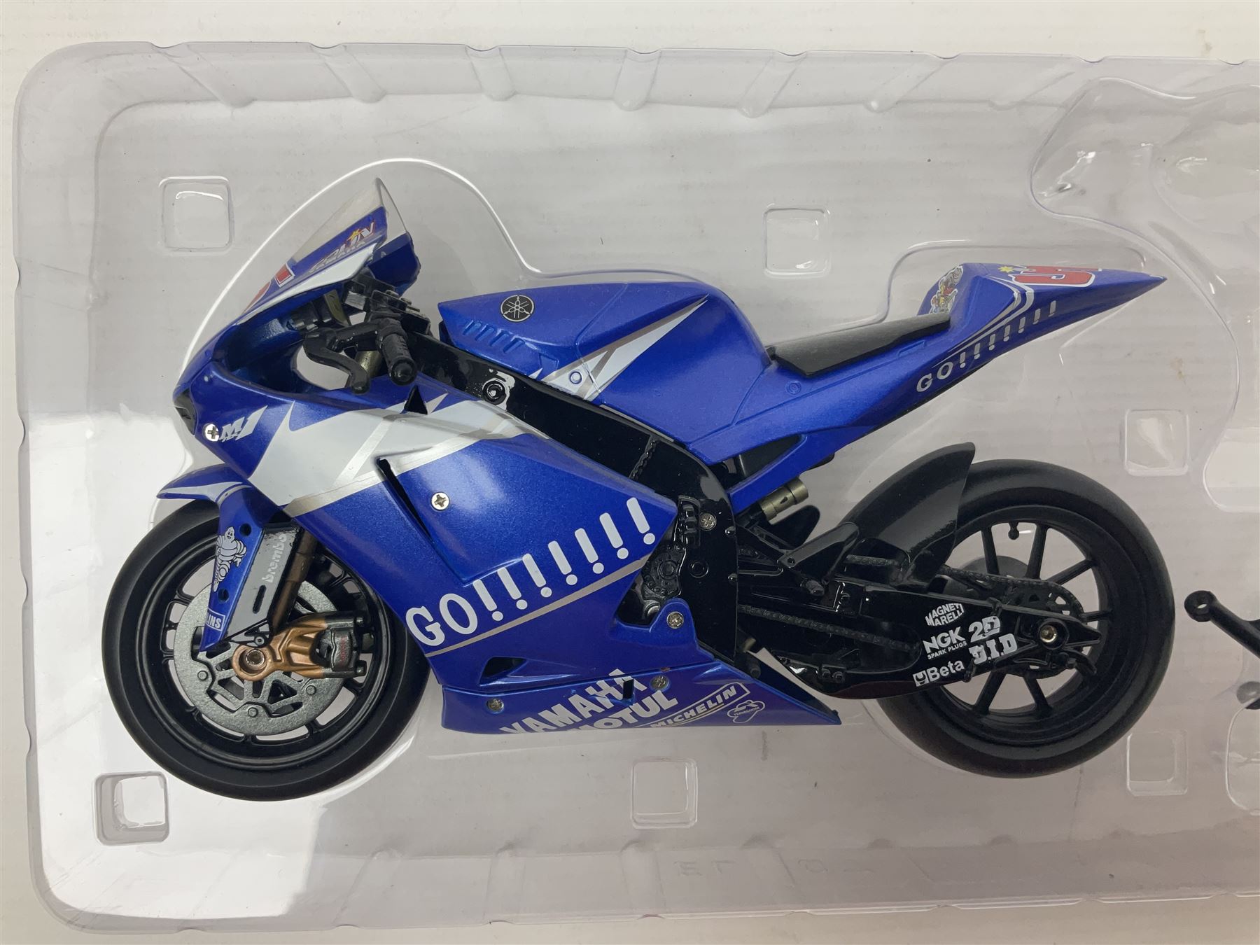 Three Minichamps 1:12 scale die-cast models of motorcycles - Suzuki GSX-R1000 Team Alstare Suzuki Corona Extra Troy Corser WSB 2005; Yamaha YZR-M1 Gauloises Yamaha Team Colin Edwards MotoGP Laguna Seca 2005; and Honda NSR 500 Loris Capirossi MotoGP 2002; all boxed (3)