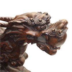 Chinese carved hardwood dragon throne chair, the shaped and pierced back with entwined dragons and cloud motifs, sweeping dragon-form arms terminating in carved heads, solid panel seat over foliate carved apron, on four mask carved cabriole supports