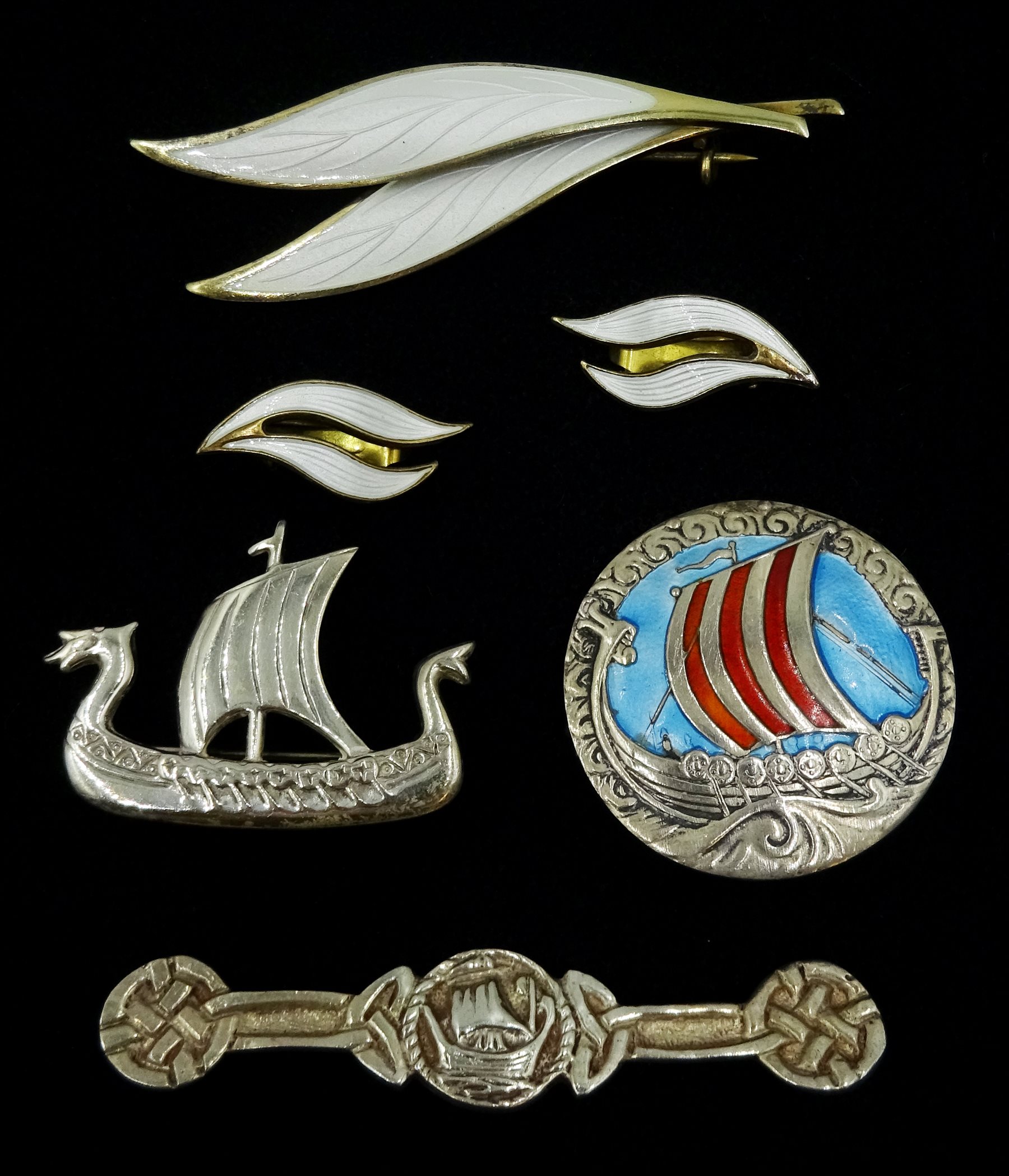Norwegian silver and enamel Viking ship boat by Andresen & Scheinpflug, silver-gilt leaf brooch by N.M. Thune , similar pair of earrings by Aksel Holmsen, silver Viking ship by Ola M Gorie and one other silver brooch